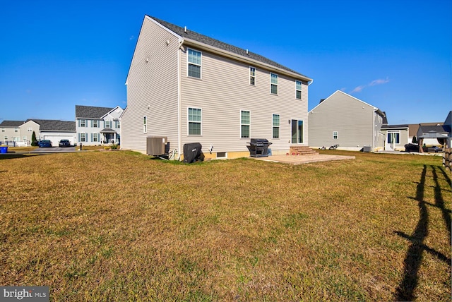 rear view of property with a residential view, entry steps, central AC unit, a lawn, and a patio area