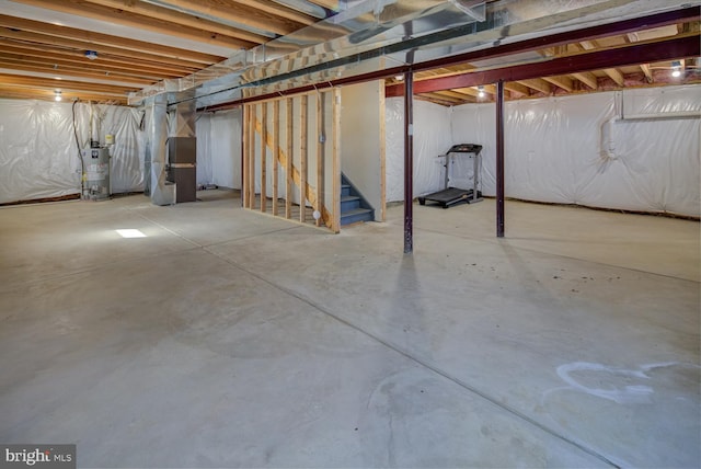 basement featuring water heater and heating unit