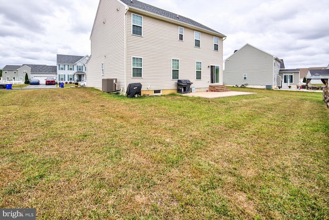 back of house featuring central AC, a yard, and a patio area