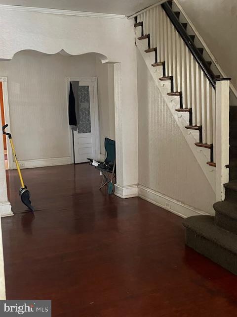 interior space featuring crown molding and wood-type flooring