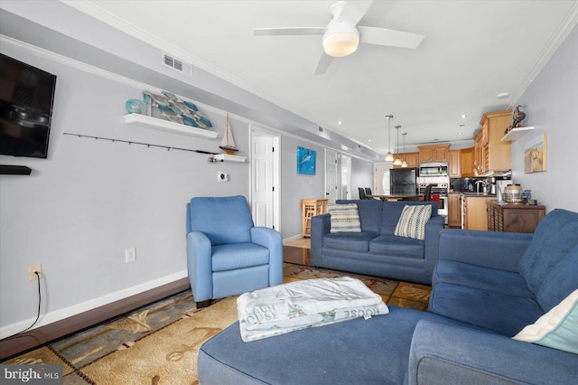 living room with ceiling fan and ornamental molding