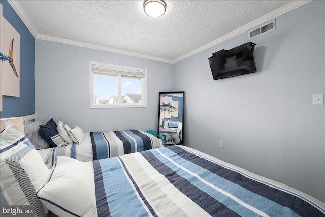 bedroom with ornamental molding and a textured ceiling