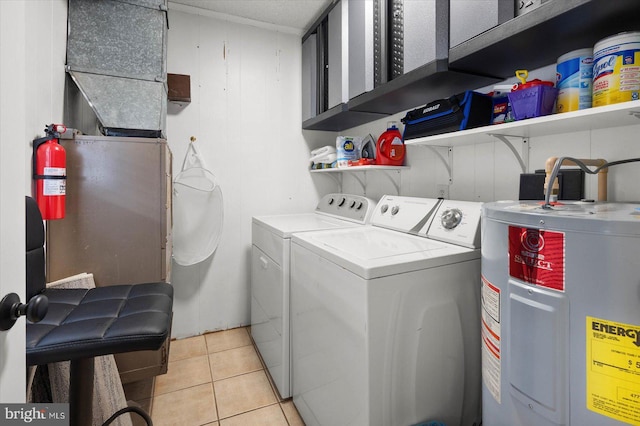 washroom with cabinets, light tile patterned flooring, separate washer and dryer, and electric water heater