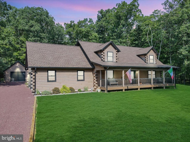 view of front of home with an outbuilding, a garage, and a yard