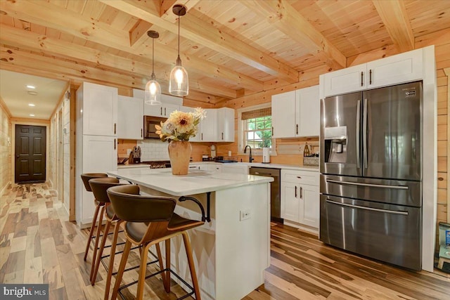 kitchen with light hardwood / wood-style flooring, stainless steel appliances, white cabinets, wood ceiling, and a kitchen island