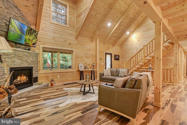 living room with light hardwood / wood-style floors, wood walls, and wood ceiling