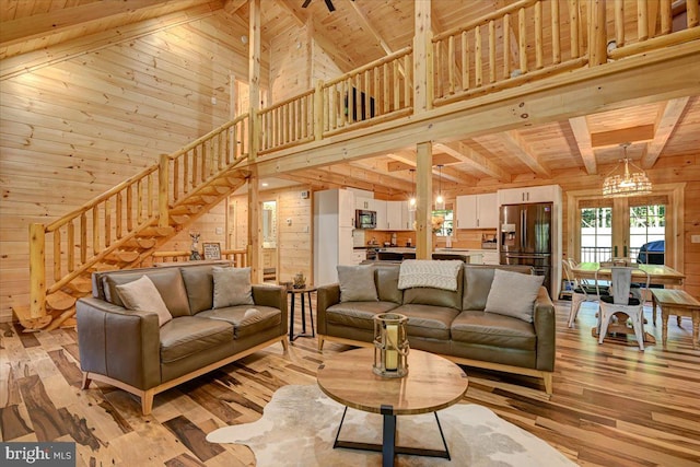 living room with high vaulted ceiling, wood walls, light wood-type flooring, and wooden ceiling