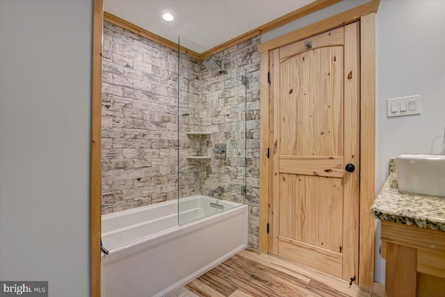 bathroom featuring vanity and enclosed tub / shower combo