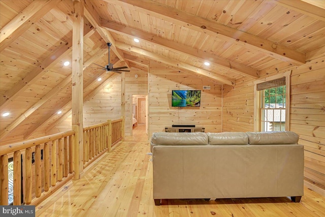 unfurnished living room with ceiling fan, vaulted ceiling with beams, light wood-type flooring, wood walls, and wood ceiling