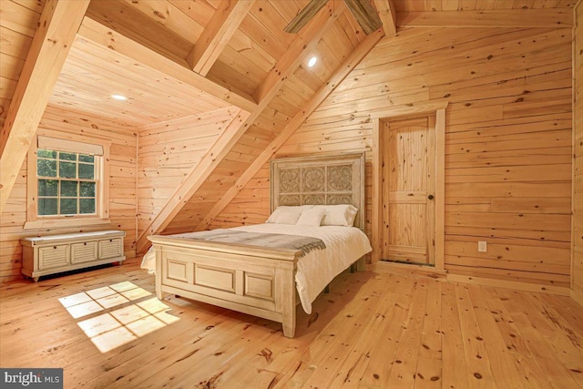 bedroom with lofted ceiling with beams, wooden ceiling, wooden walls, and light hardwood / wood-style floors