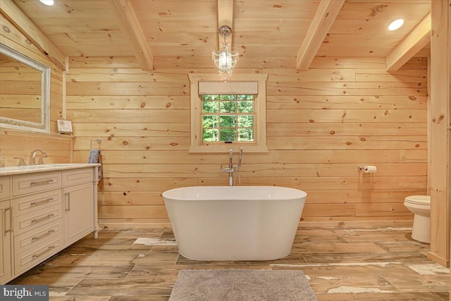 bathroom with beam ceiling, wood walls, hardwood / wood-style floors, and vanity