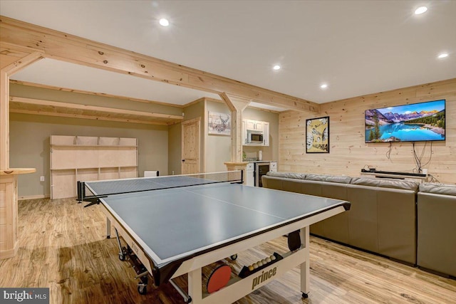 game room featuring wood walls and light hardwood / wood-style flooring