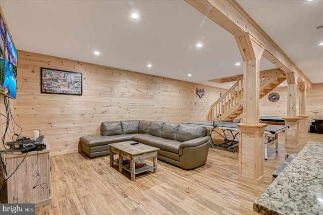 living room featuring wood walls and light hardwood / wood-style floors