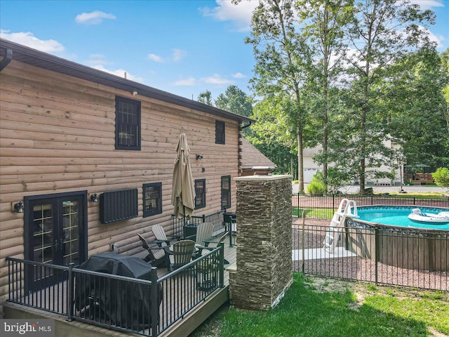 back of house with a fenced in pool