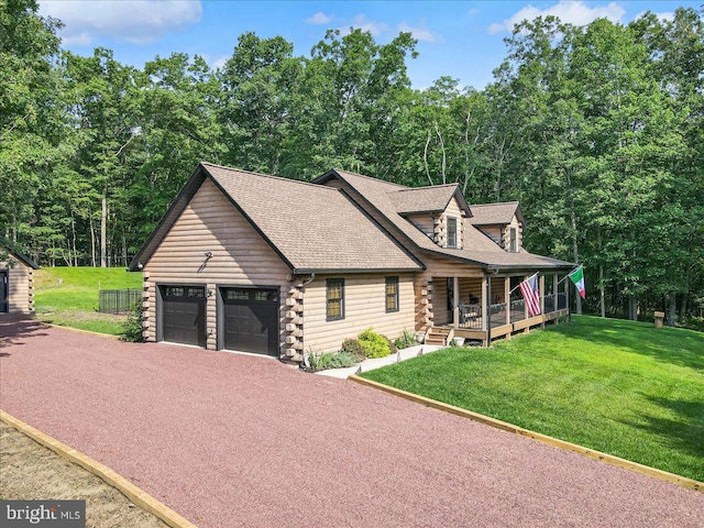 cabin featuring a garage and a front lawn