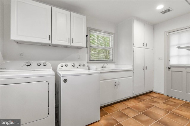 laundry room featuring cabinets, washer and clothes dryer, sink, and light tile patterned floors