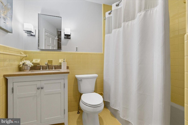 full bathroom featuring tile walls, vanity, toilet, and shower / bathtub combination with curtain