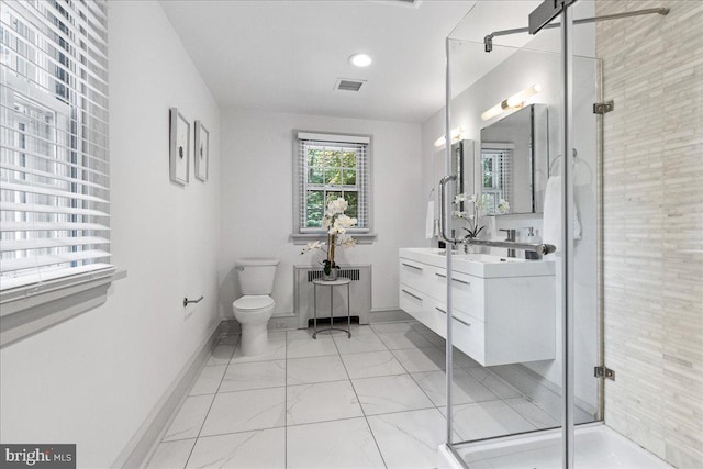 bathroom with vanity, toilet, radiator, and a shower with door