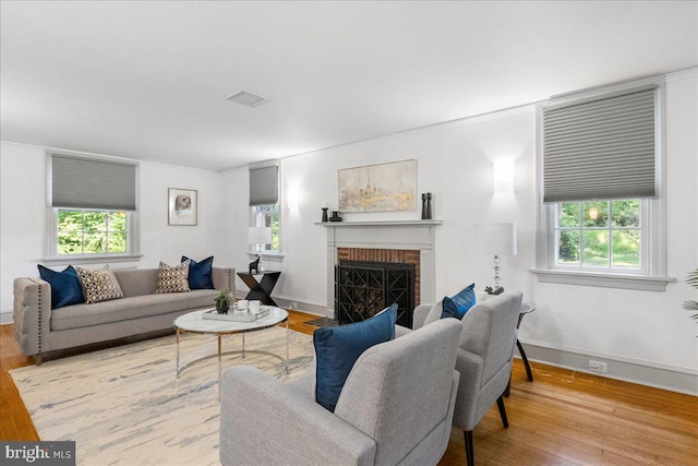 living room with wood-type flooring and a fireplace