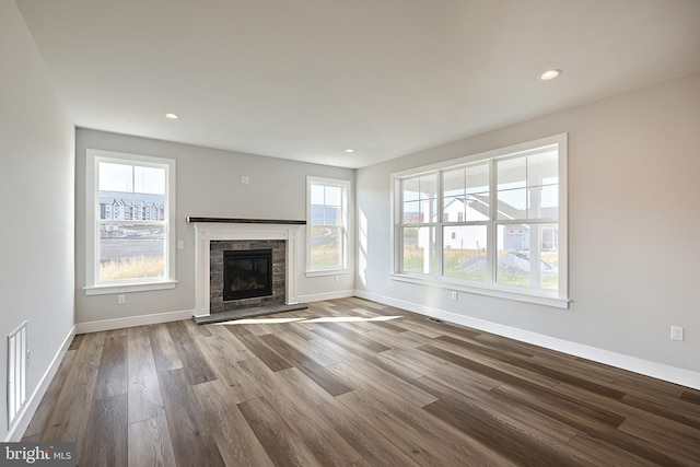 unfurnished living room featuring a fireplace and wood-type flooring