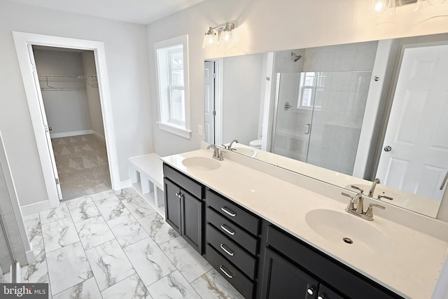 bathroom featuring vanity, toilet, and a shower with shower door