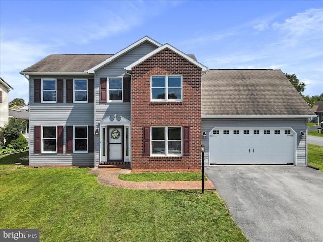 view of front of home with a garage and a front lawn