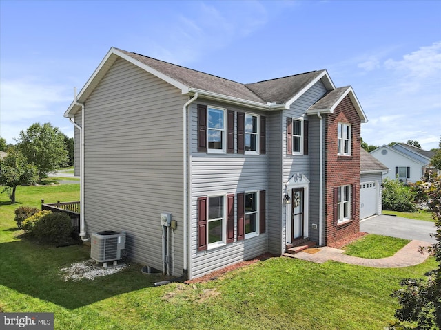 view of front of home featuring central AC unit, a garage, and a front lawn