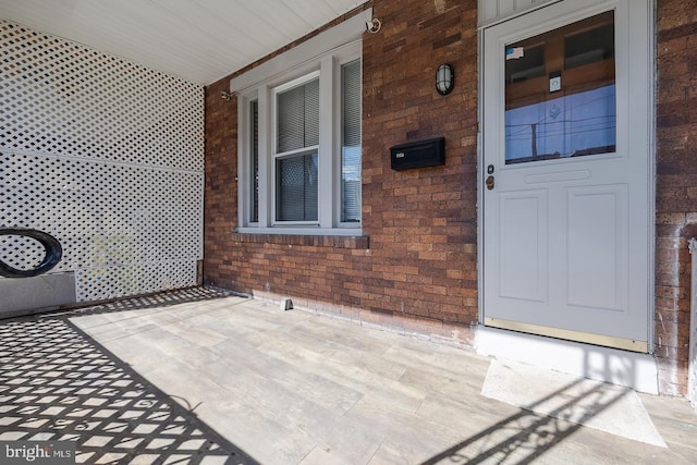 view of exterior entry with covered porch