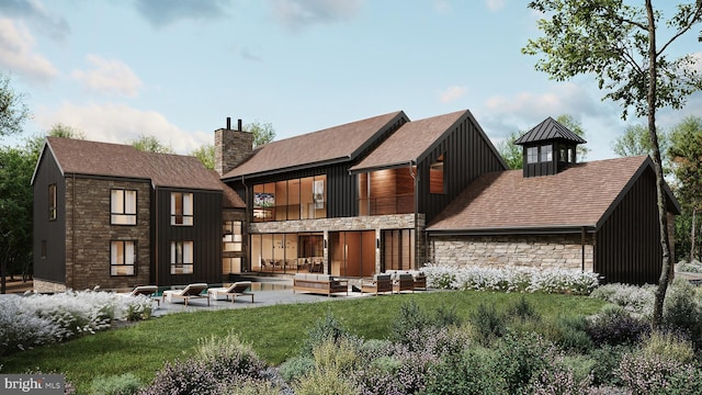 rear view of property with stone siding, a chimney, a lawn, and a patio