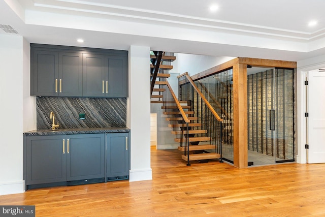 607 W Gravers Ln, Philadelphia, PA 19118 - bar featuring light wood-style flooring, backsplash, recessed lighting, stairway, and a raised ceiling