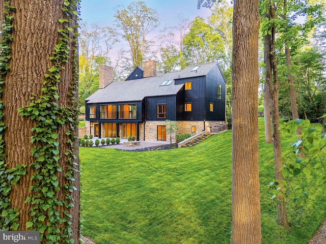 607 W Gravers Ln, Philadelphia, PA 19118 - rear view of property featuring a chimney, a yard, and a shingled roof
