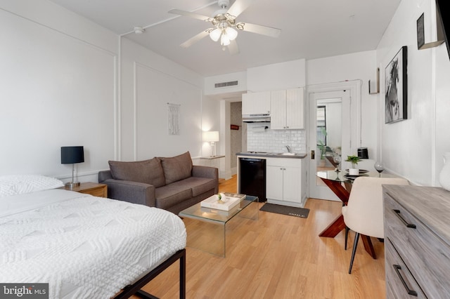 bedroom with a ceiling fan, visible vents, and light wood-style flooring