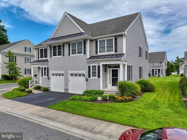 view of front facade featuring a garage and a front lawn