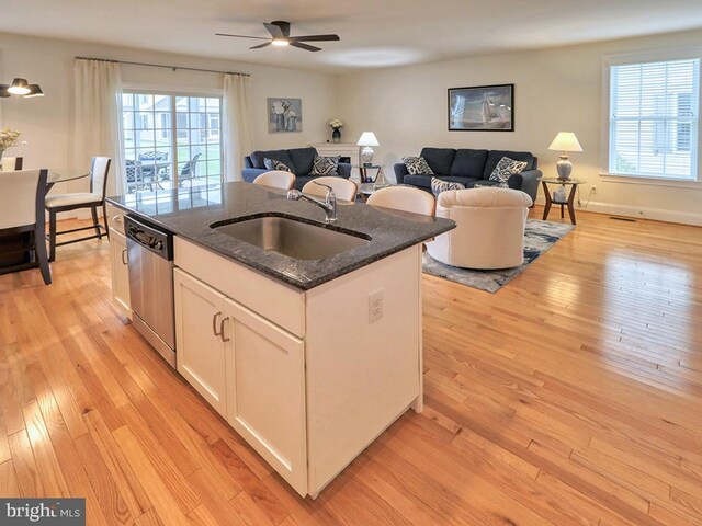 kitchen featuring dishwasher, light wood-type flooring, and white cabinets