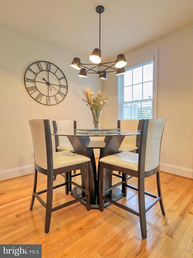 dining room featuring light hardwood / wood-style flooring and a chandelier