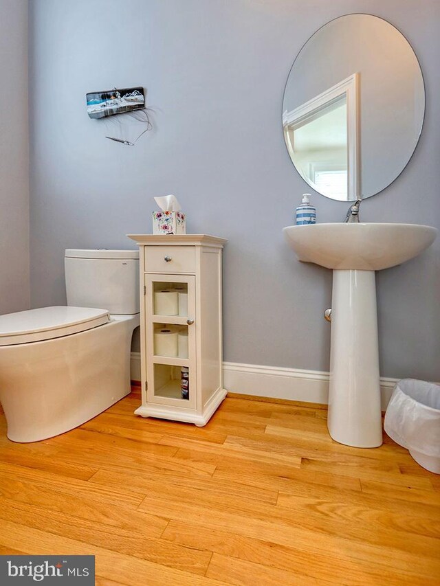 bathroom featuring hardwood / wood-style flooring and toilet