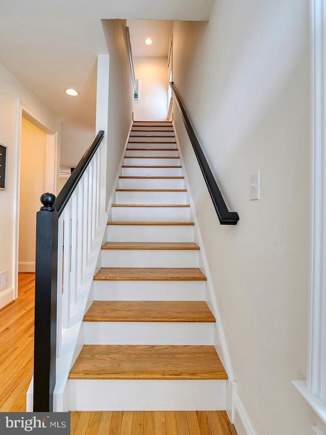 staircase with light wood-type flooring