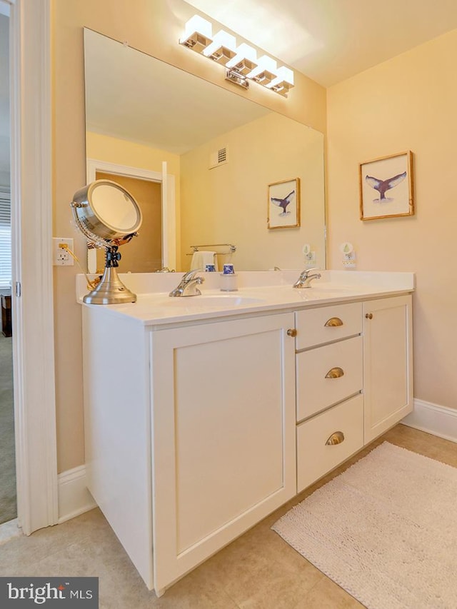 bathroom featuring tile patterned floors and double sink vanity