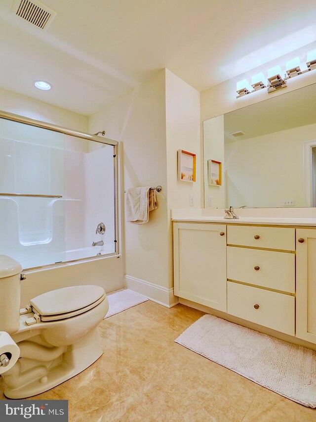 full bathroom featuring tile patterned flooring, bath / shower combo with glass door, toilet, and vanity