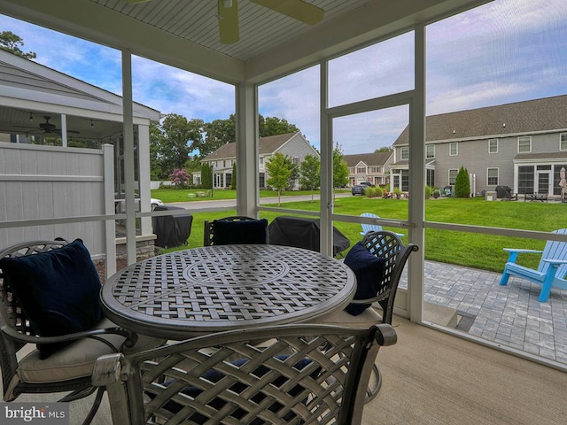 sunroom featuring ceiling fan