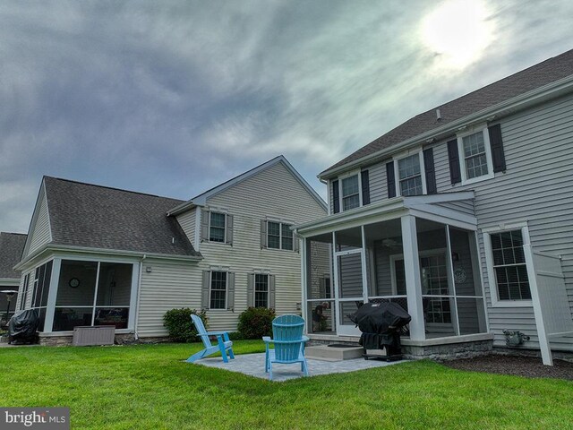 back of property featuring a yard, a sunroom, and central AC