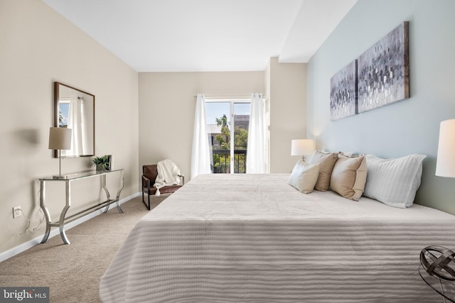 carpeted bedroom featuring baseboards