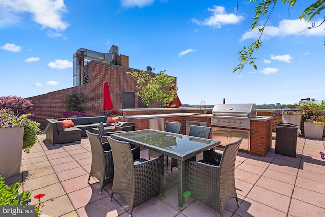 view of patio / terrace featuring a grill, area for grilling, sink, and an outdoor hangout area