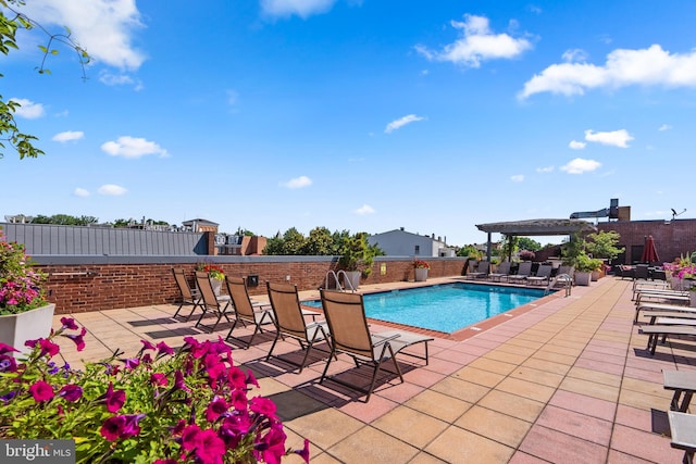 pool featuring a patio area and a pergola