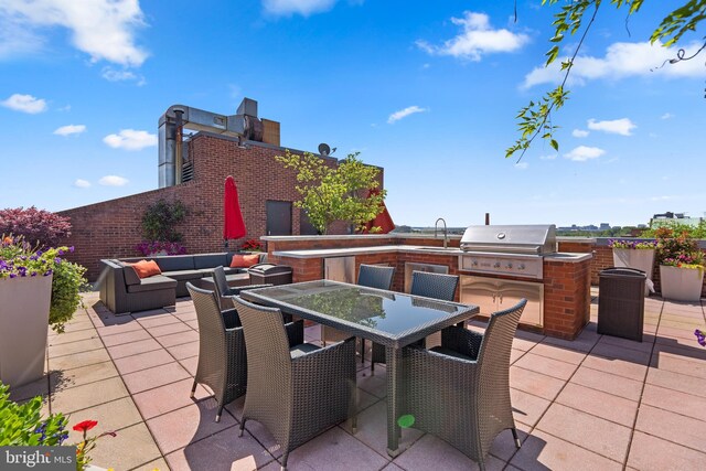 view of patio / terrace featuring area for grilling, an outdoor kitchen, sink, and an outdoor living space