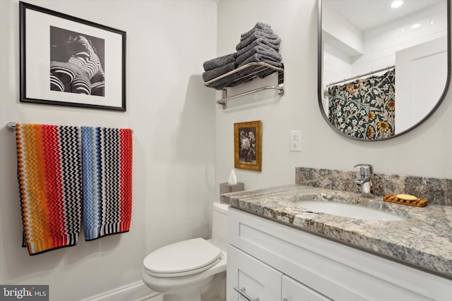 bathroom with vanity, toilet, and a shower with curtain