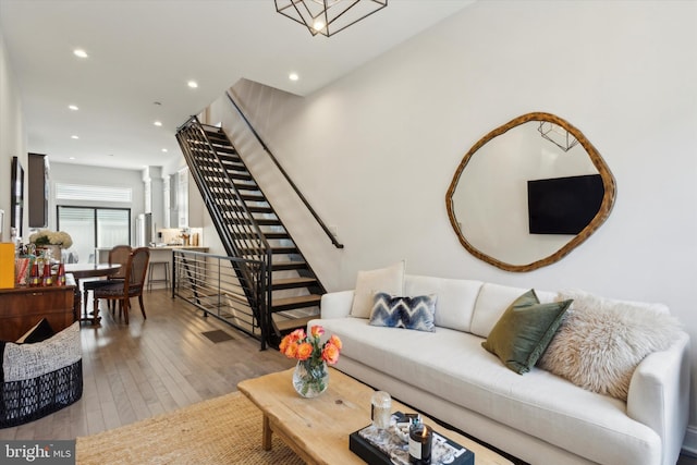 living room featuring light wood-type flooring and decorative columns