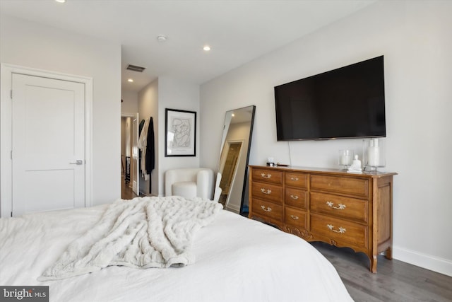 bedroom with dark hardwood / wood-style floors