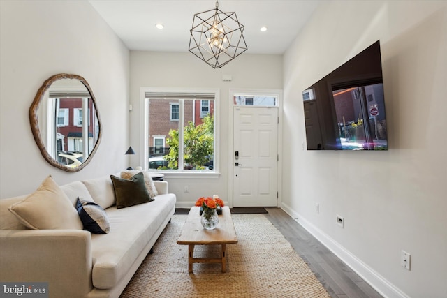 living room with hardwood / wood-style floors and an inviting chandelier