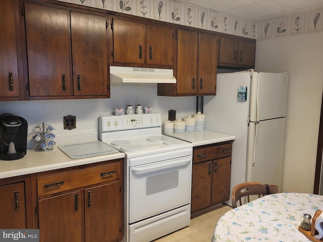 kitchen with white appliances and light tile patterned floors